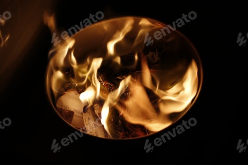 Preview: Selective focus closeup of the burning paper inside a bowl