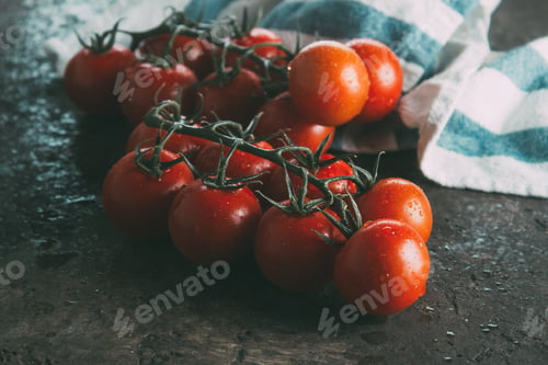 Preview: Fresh cherry tomatoes on a dark brown background.