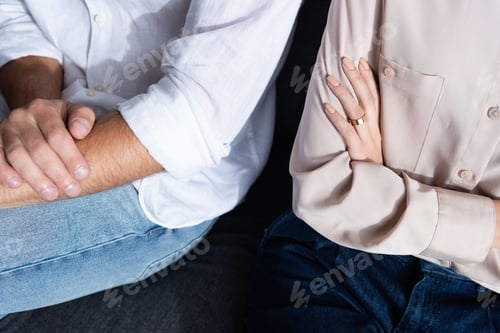 Preview: partial view of woman and man with crossed arms