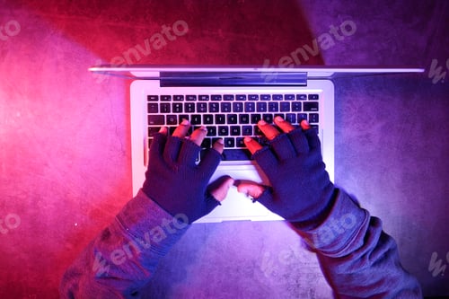 Preview: top view of hacker hand stealing data from laptop