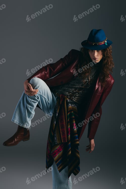 Preview: Stylish young man showcasing modern fashion in a creative studio setting