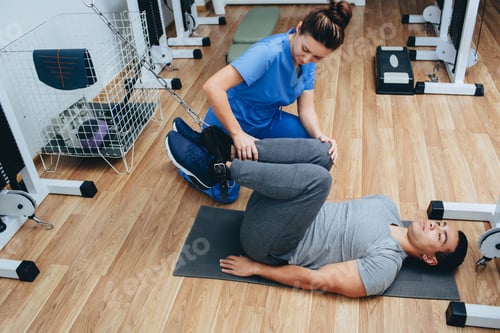 Preview: Physical Therapist Assists Patient with Exercise Machine
