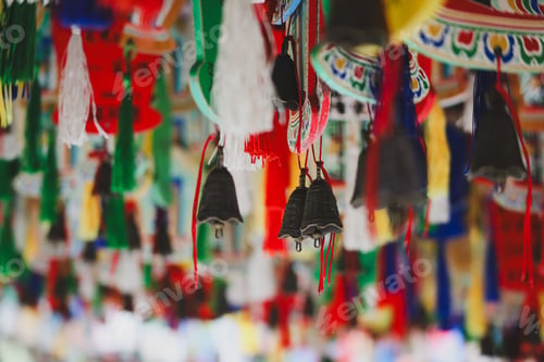 Preview: Colorful hanging decorations and bells in an Asian market or temple.