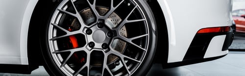Preview: KYIV, UKRAINE - OCTOBER 7, 2019: panoramic shot of black car wheel in white porshe