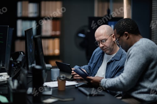 Preview: Middle Aged Caucasian Man and Young Black Man Collaborating in Office