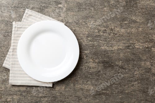 Preview: Top view on colored background empty round white plate on tablecloth for food. Empty dish