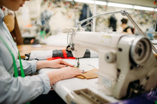 Preview: Tailor hands sews fabrics on a sewing machine