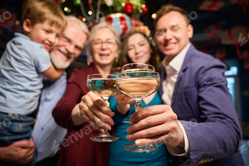 Preview: Clinking glasses with champagne in hands of group of people at Christmas