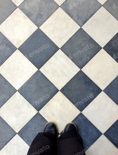 Preview: low section of woman standing on vintage tiled floor
