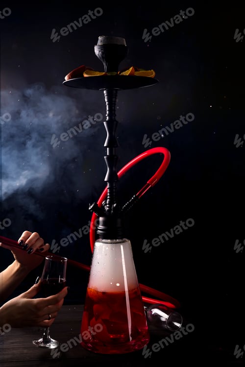 Preview: A girl with a glass of red wine smokes a fruit hookah