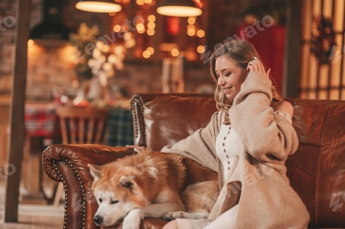 Preview: Candid authentic happy married couple spends time together with japanese dog at Xmas lodge
