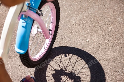Preview: Close up wheel of children's bikes riding on asphalt road summertime outdoors