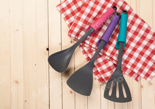 Preview: cookware and accessories on a wooden table.
