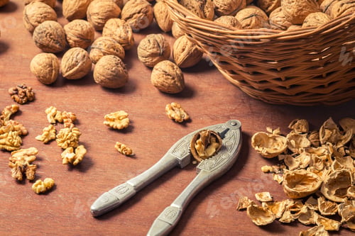 Preview: Closeup of cracking walnuts on old wooden table