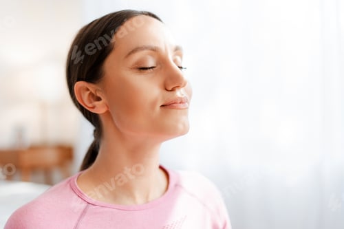 Preview: Beautiful women with closed eyes breathing while relaxing after exercising workout