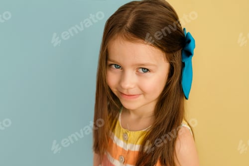 Preview: Blue-eyed girl with a big bow in her long hair.