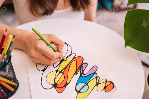 Preview: Lady paints over a drawing on a white sheet with colored pencils