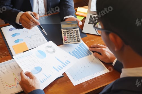Preview: Business Professionals Reviewing Graphs and Financial Data
