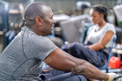 Preview: Mechanical guy at garage car repair shop sitting talking general topic