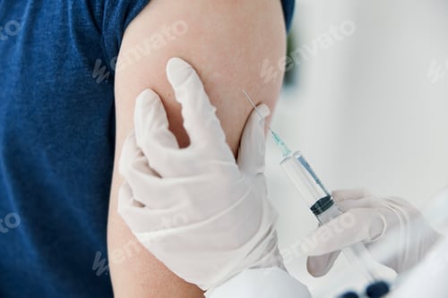 Preview: woman doctor in protective gloves injections in the shoulder of a man covid