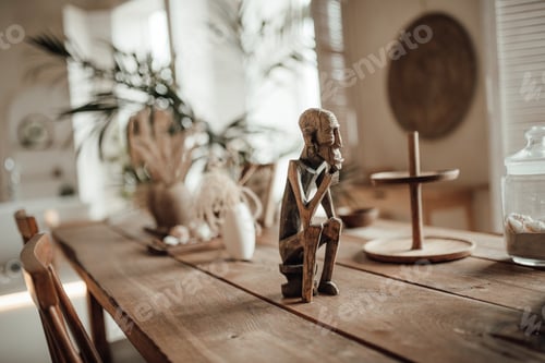 Preview: Wooden Statue on a Table with Decorations