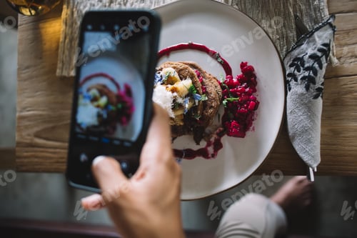 Preview: Woman taking photo of tasty colorful food on smartphone