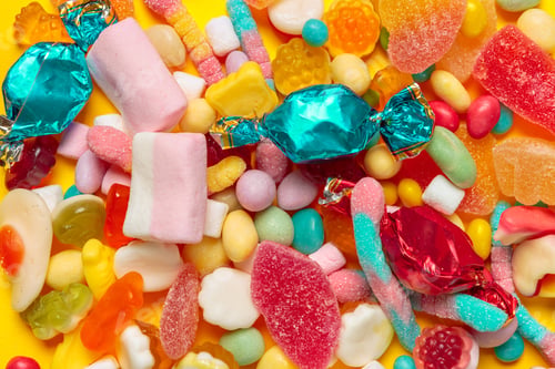 Preview: colored candies on yellow background