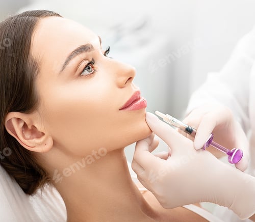 Preview: Woman having procedure lip augmentation. Syringe near womans mouth, injections for increase lips