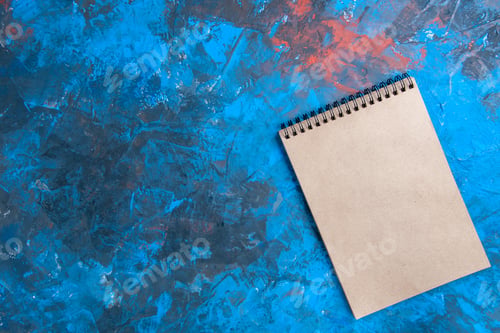 Preview: top view a notebook on blue background copy space