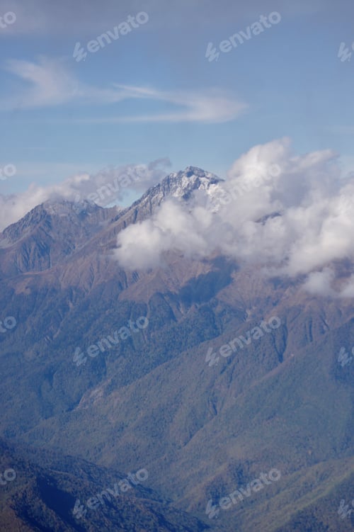 Preview: Snow Capped Mountains Enshrouded in Clouds and Mist