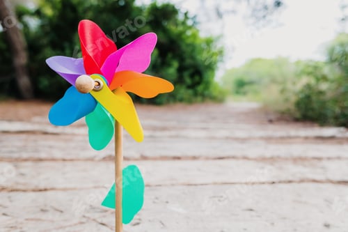 Preview: Natural background with the colorful image of a toy pinwheel representing a prosperous future.