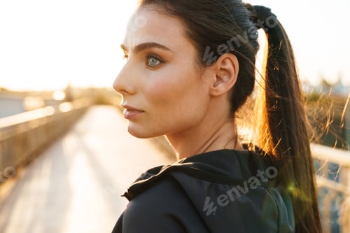 Preview: Woman in Workout Clothes on Bridge at Sunrise