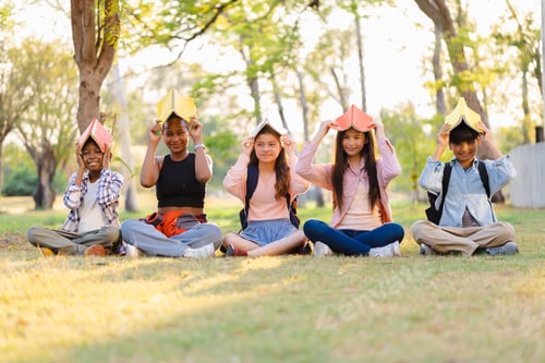 Preview: Diverse student concepts. Happy Diverse students in park at sunset
