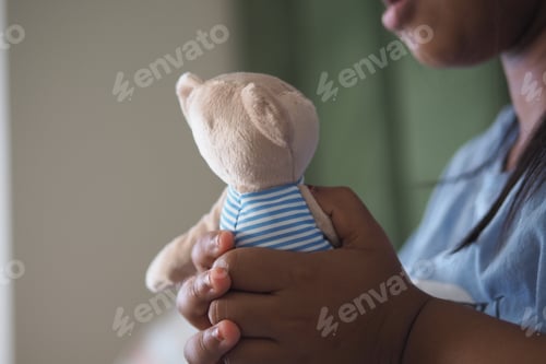 Preview: Child holds stuffed animal with care and affection