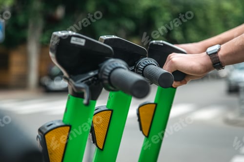 Preview: Electric scooters in a city are available for rent. close up.