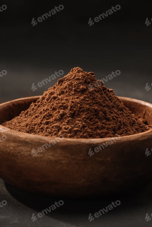 Preview: close up of cocoa powder in wooden bowl on table