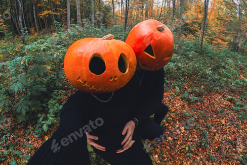 Preview: Silhouetted Figures with Pumpkin Heads in Autumn Forest