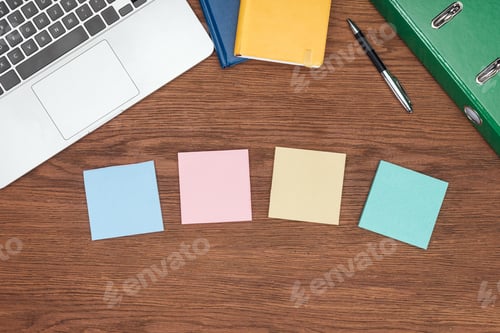 Preview: top view of four sticky notes, laptop and office supplies on wooden desk