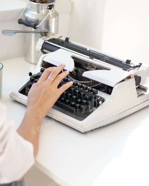Preview: Girl typing on a typewriter