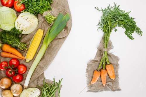 Preview: food composition with fresh vegetables arranged on sackcloth isolated on white