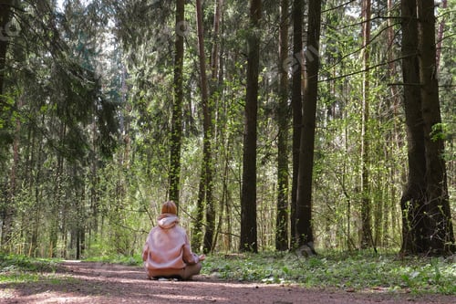 Preview: Woman Inhaling Incense Smoke During Meditation.Ground level of relaxed female meditating and breathi