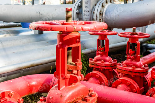 Preview: Close up of red industrial pipes and valves at biofuel industrial plant