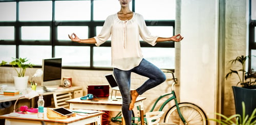 Preview: Female business executive performing yoga