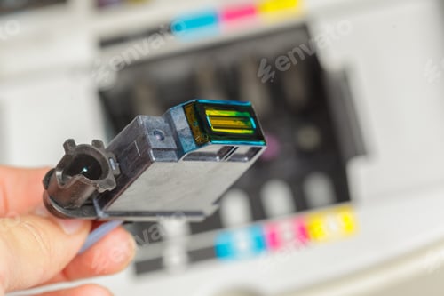 Preview: Ink cartridge replacement in a printer at an office during work hours