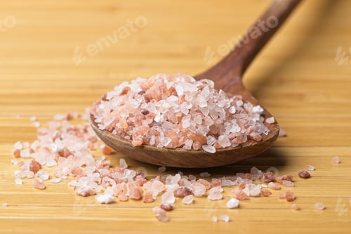Preview: Close up of Himalayan pink salt on a wooden spoon.