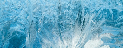 Preview: Frosty patterns on glass. Christmas background. Ice on winter window. Abstract crystals close up.