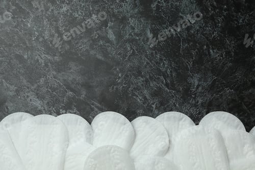 Preview: Sanitary pads on black smokey background, space for text