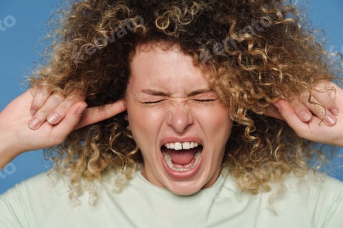 Preview: Blonde woman in t-shirt screaming while plugging her ears