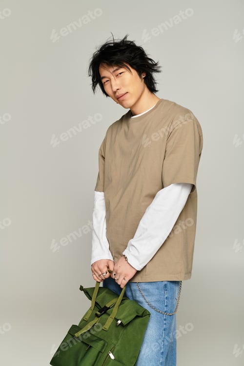 Preview: Handsome young asian man showcasing modern streetwear in a stylish urban setting