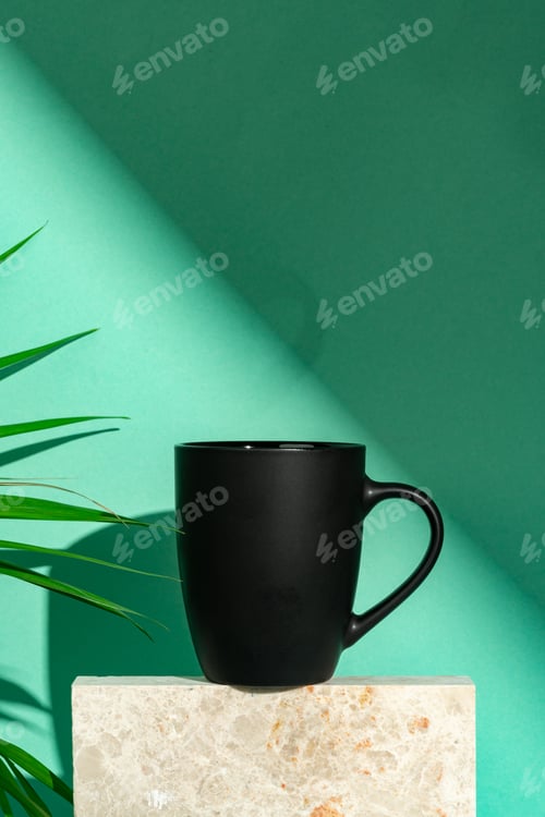 Preview: Porcelain mug and palm leaf against mint background